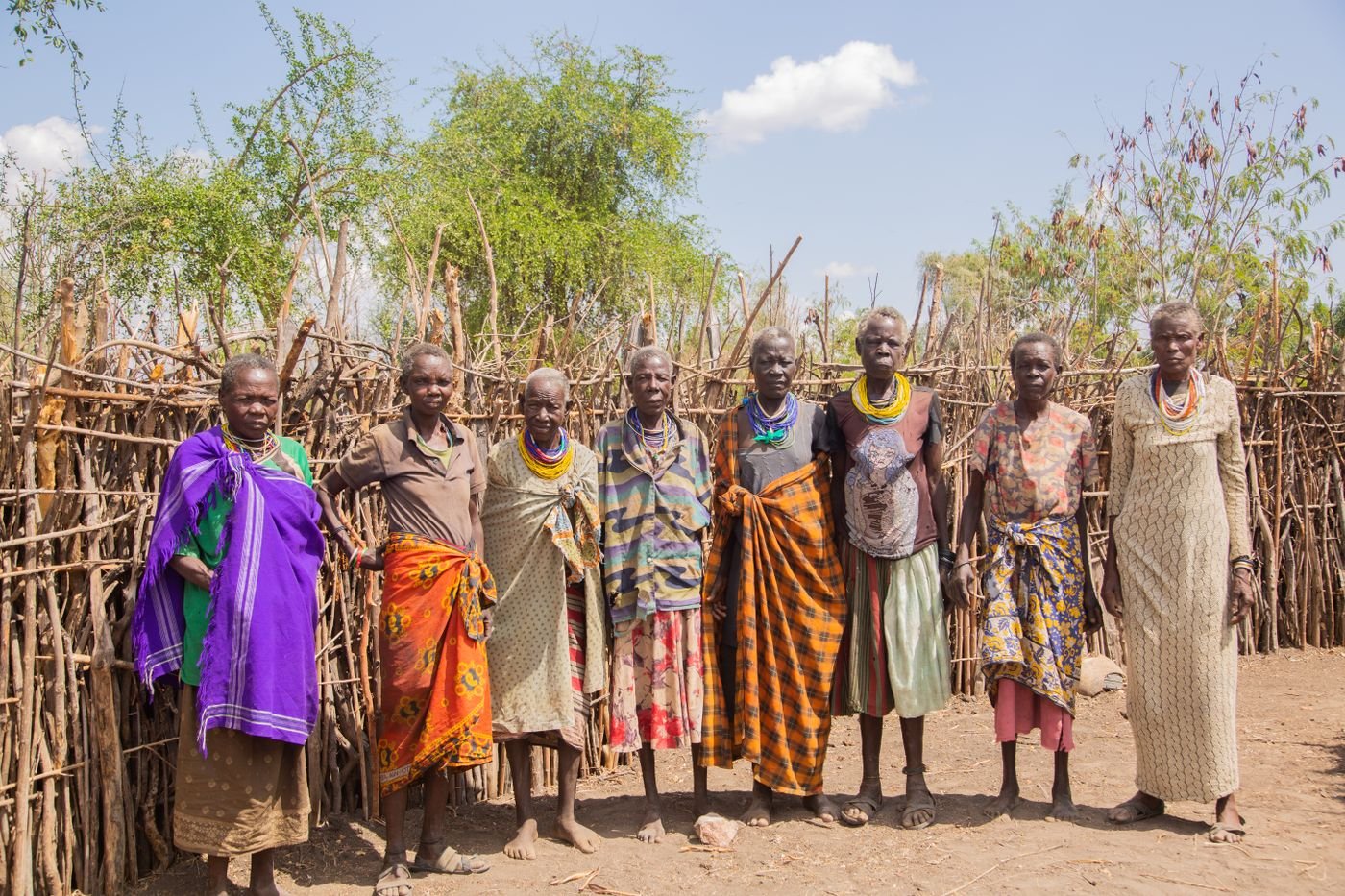 Elders gathered together outdoors in colourful attire