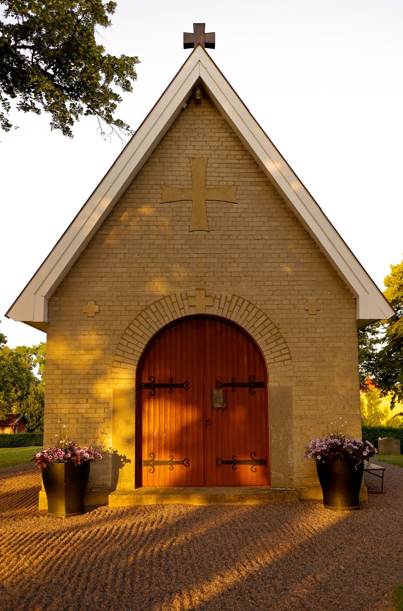 A small chapel glowing in evening sunlight